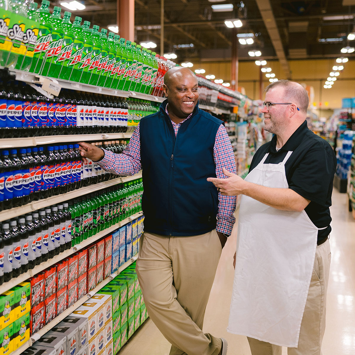 Photo of sales team member talking with stores clerk about product