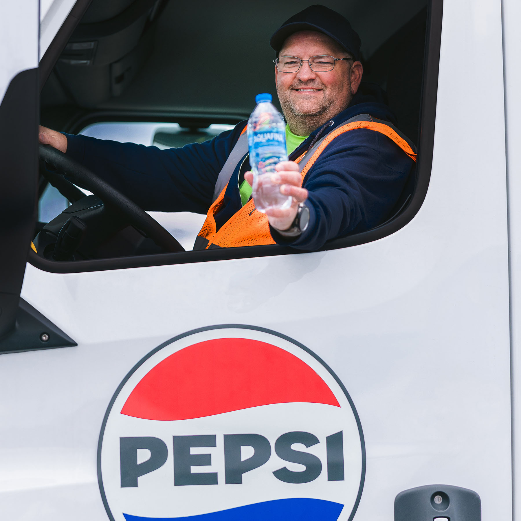 Photo of CDL driver holding out a Pepsi product